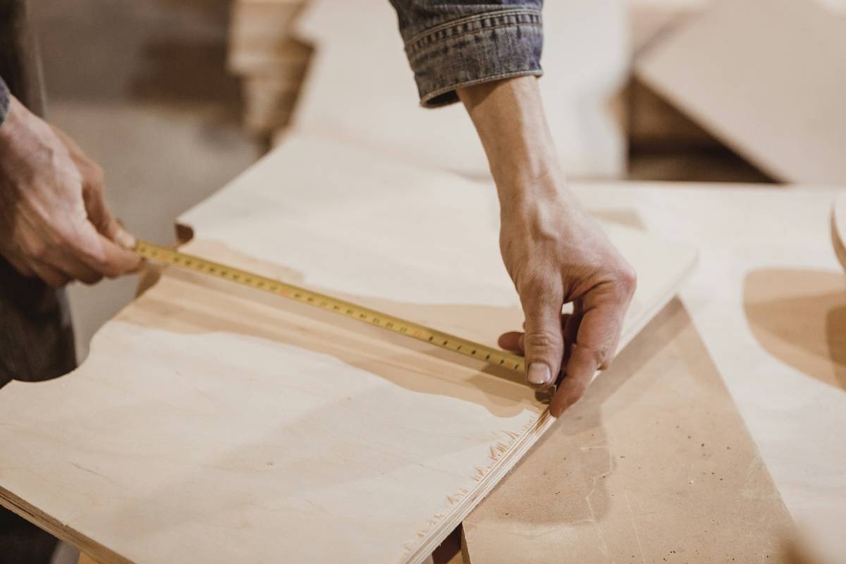 power tool miter saw technique using a properly aligned sliding compound miter saw cutting hardwood trim with dust collection attached