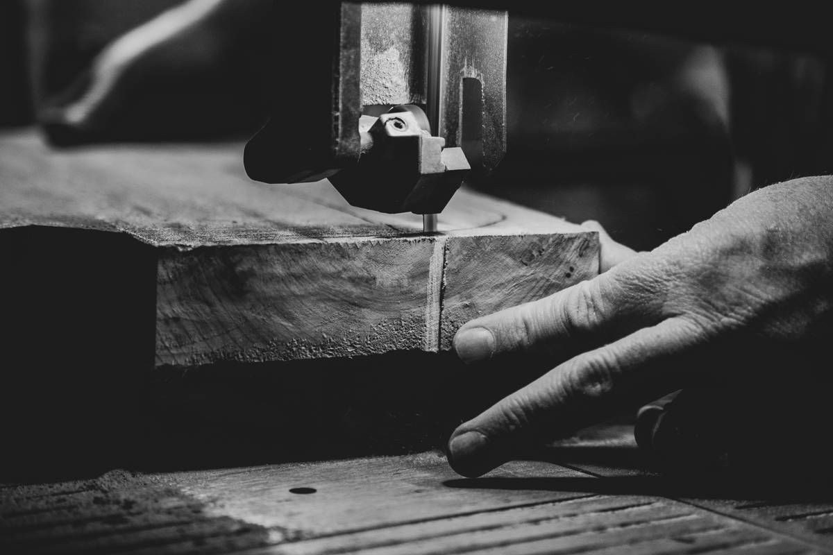 Professional using a miter saw for woodworking on hardwood trim with accurate angle alignment