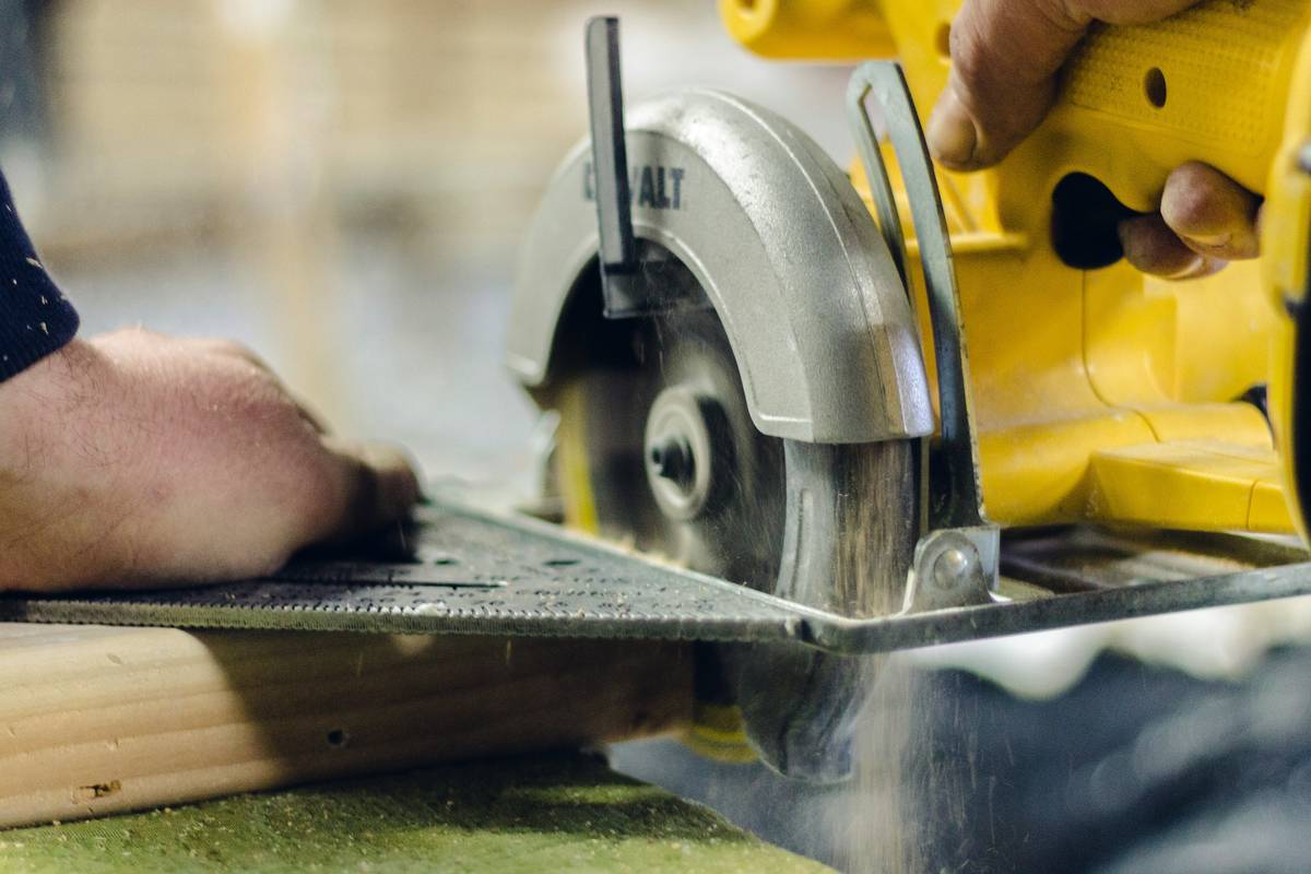 Carpenter using a mitre saw to cut crown molding at precise angles