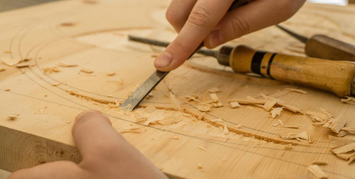 miter saw cutting guide showing precise angle alignment on a DeWalt sliding compound miter saw with marked wood stock