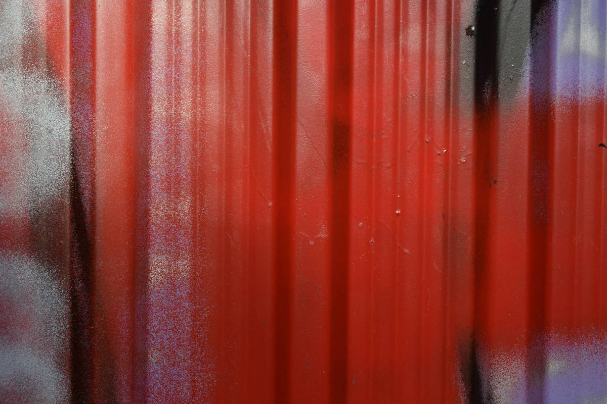 r panel paint roller in use on corrugated metal wall showing even coverage and no streaking